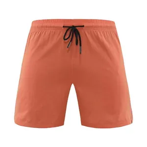 Front view of orange quick-dry men's sports shorts with adjustable black drawstring.
