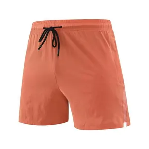 Detail view of men's quick-dry running shorts in orange featuring breathable side mesh
