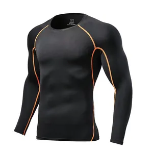 Detailed view of black long-sleeve compression shirt with orange contrast stitching