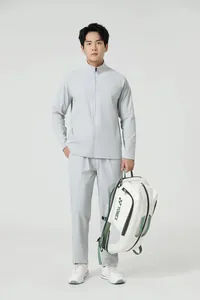 Mannequin asiatique portant un ensemble de sport gris respirant avec veste à col montant.