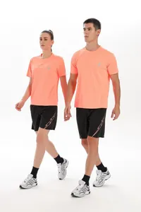 Athletic male and female models in quick-dry coral t-shirts and black shorts running set