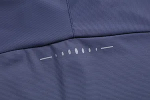 Close-up view of dark blue quick-dry athletic fabric with gray reflective safety strip detail