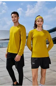 Athletic couple in yellow long-sleeved quick-dry running shirts and black shorts.