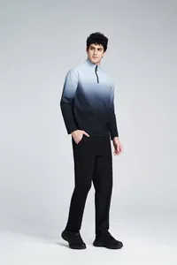 Full body view of a man wearing a gradient blue to black half-zip sports pullover shirt.