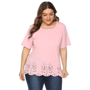 Detail view showing laser-cut floral pattern on the scalloped hem of a pink top