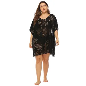 Detail showing the intricate black lace texture and flowy design of this beach cover-up