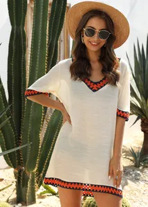 Front view of white crochet V-neck beach cover-up worn by model in desert setting