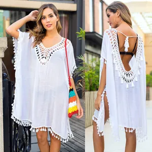 Close-up detail of the front and back of a white crochet tassel beach cover-up tunic