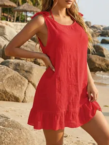 Detailed view of red bikini cover-up featuring ruffle hem and adjustable shoulder ties