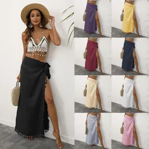 Detail view showing multiple color options of the tassel tie-waist beach wrap skirt