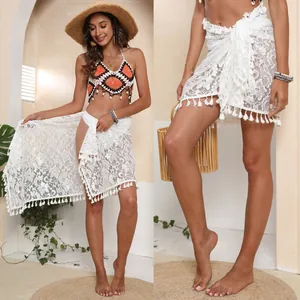 Detailed view of white lace beach sarong with tassel hem and tie-up waist design