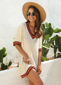 Loose cream beach cover-up featuring colorful contrast crochet trim and V-neckline detail