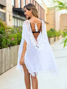 Back view of white crochet beach cover-up with tassels and sexy open-back design