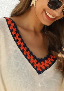 Detailed view of V-neckline with hand-crocheted contrast stitching on beach cover-up