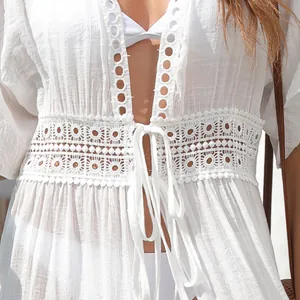 White lace-up beach cover-up with hollow-out lace detailing and long cardigan style