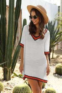 Detail of white crochet hollow-out V-neck beach cover-up with color block trim.