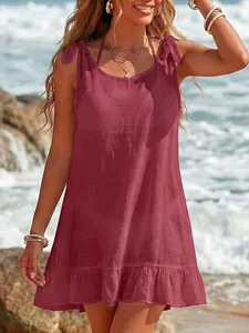 Detailed view of maroon bikini cover-up featuring adjustable shoulder ties and ruffles