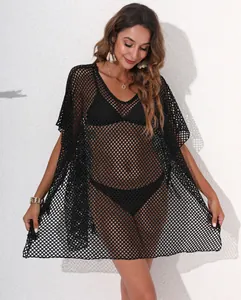 Detail view of the sexy black mesh beach cover-up featuring intricate hollow-out knit texture.