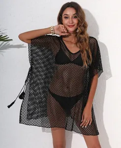 Detailed view of women's black mesh beach cover-up featuring V-neckline and tassel side ties