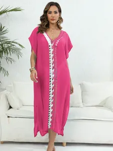 Vibrant pink beach cover-up with white crochet detail and deep V-neck