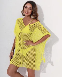 Bright yellow crochet mesh beach cover-up with stylish tassel details and elegant V-neckline