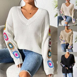Pull à col en V avec des manches en patchwork de fleurs au crochet colorées.