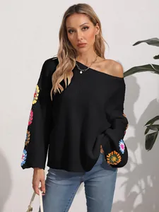 Women's off-shoulder black knit pullover sweater with colorful crochet floral sleeves.