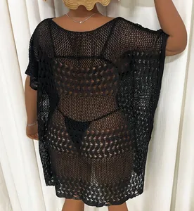 Close-up back view of a plus size black crochet hollow-out beach cover-up dress