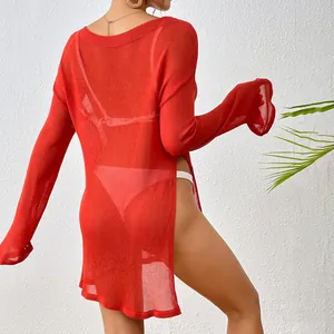 Detail of red mesh beach cover-up featuring a high side slit and sheer texture.