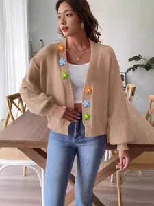 Stylish cropped beige knitted cardigan for women with colorful crochet flower details