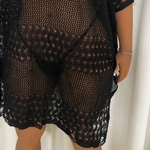 Detailed close-up of a black plus size hollow-out crochet beach dress showing the knit texture