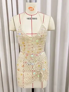 Detailed view of handmade crochet beach cover-up set with iridescent sequins and tassels