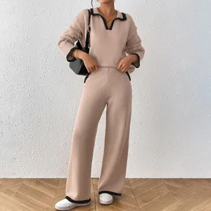 Two-piece women's knit set with contrast polo collar and matching wide-leg pants.