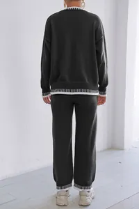 Detailed rear view of women's dark grey knitted lounge set with contrast white stripes