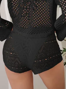 Detailed macro view of black hollow-out crochet lace mini shorts for women beachwear
