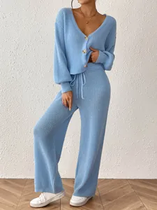 Detail of light blue knit lounge set featuring a button cardigan and wide-leg pants