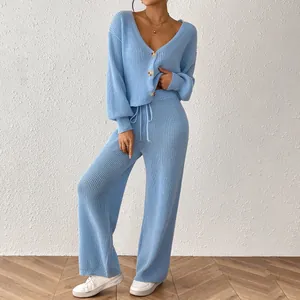 Close-up view of a light blue knitted two-piece set with a cardigan and wide-leg pants