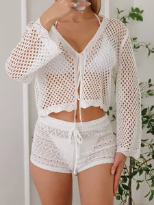 Detailed view of white crochet lace beach shorts and long sleeve top set