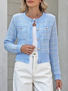 Front view of a light blue Chanel-style knit cardigan with elegant pearl button detail