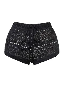 Detailed view of black crochet mini shorts with geometric patterns and drawstring