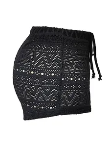 Detail view of the black crochet lace pattern and side drawstring on women's mini shorts