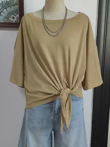 Detail view of khaki boat neck cover-up with a front tie-knot and soft texture