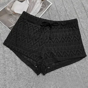 Detailed view of sexy black hollow-out lace beach shorts with drawstring waist.