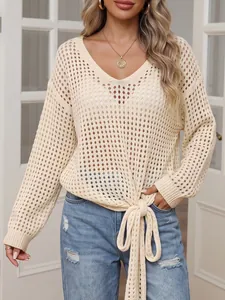 Detailed view of women's hollow-out V-neck knit cover-up with tie-front knot.