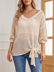 Detailed view of women's beige V-neck hollow-out crochet sweater with front tie-knot