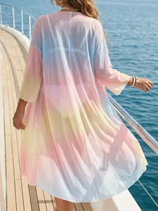 Back view of a sheer tie-dye mesh beach cover-up with a flowing gradient design.