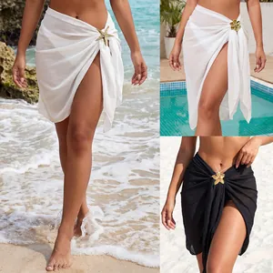 Detail view showing white and black chiffon sarongs with elegant starfish accessories.
