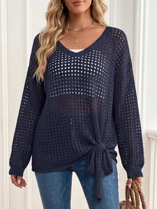Close-up detail of navy blue hollow out knit top showing the front tie-knot detail.