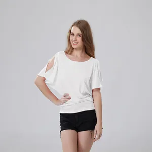 Woman wearing a white cold shoulder batwing sleeve T-shirt paired with black denim shorts