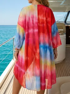 Detailed back view of a colorful tie-dye mesh beach cover-up with an irregular hemline.